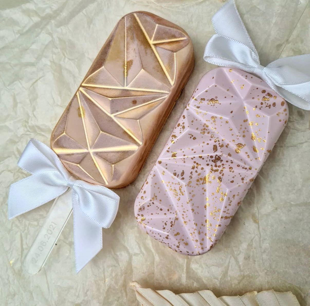 Geometric rose gold cakesicles with white ribbon bows