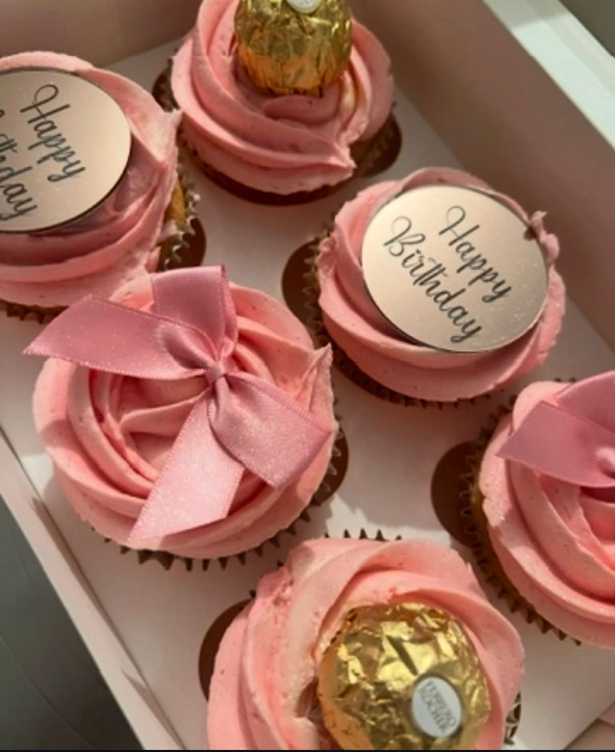 Pink Happy Birthday cupcakes with Ferrero Rocher and satin bows